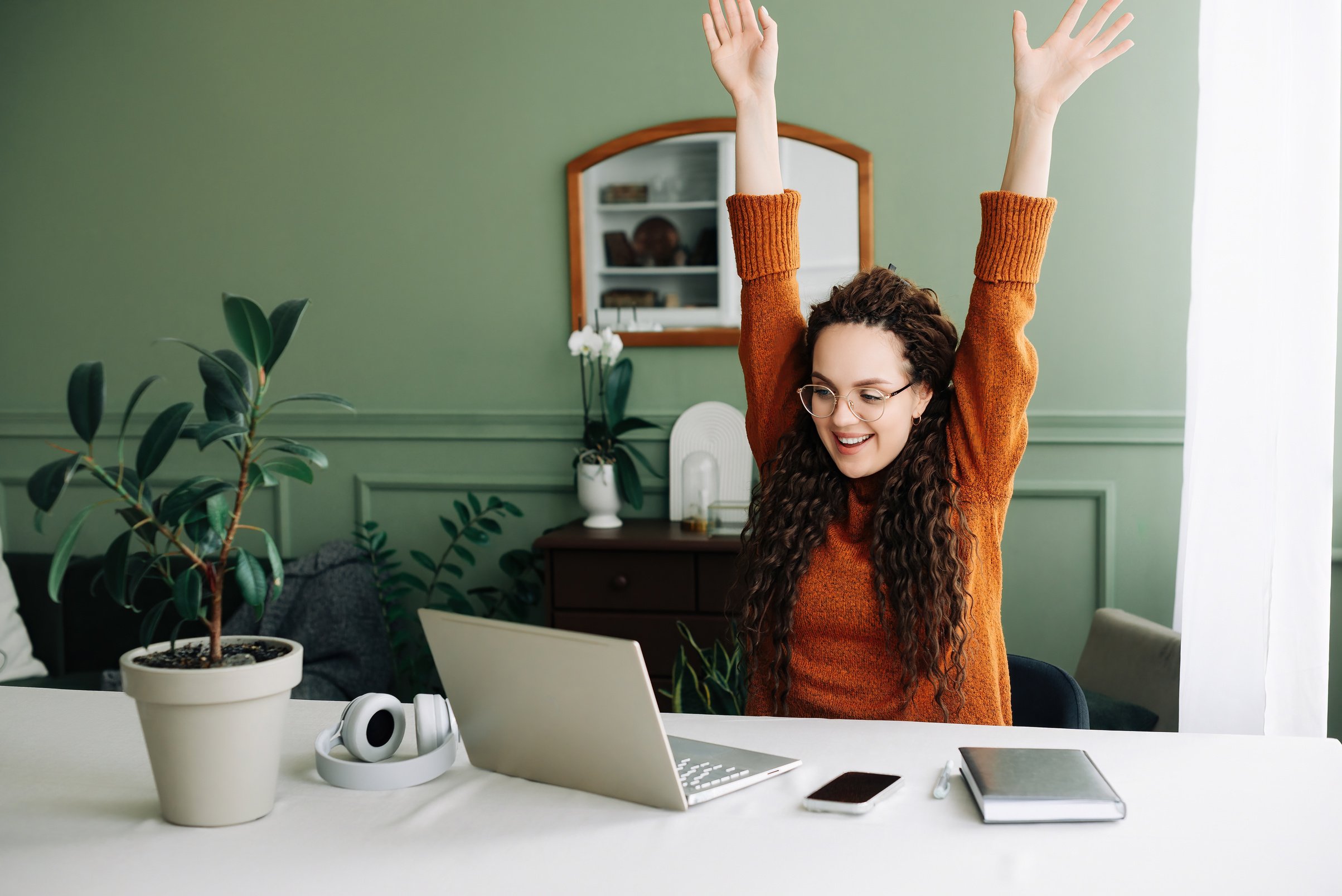 Excited Young Woman Celebrating Online Success on Laptop - Job Approval or Exam Results Achieved Winning Online and Receiving Email Approval for Exam Results or Job Opportunity.